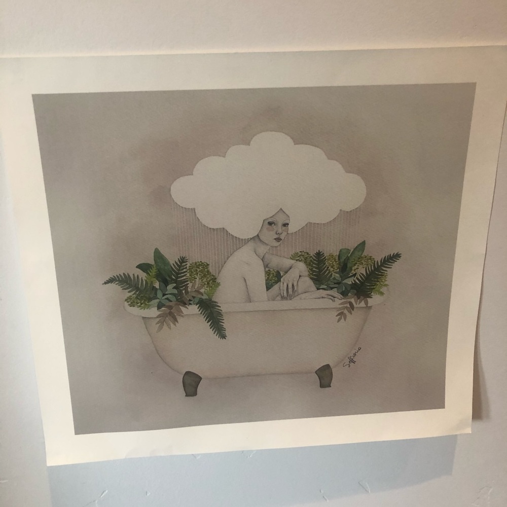 Lady in bath full of green foliage with a cloud